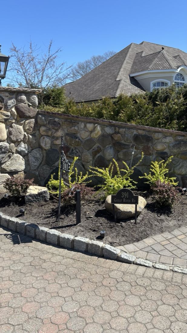 Fresh plantings along a fieldstone wall at a Great River estate